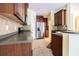 Well-lit kitchen featuring stainless steel appliances, wood cabinetry, and tile backsplash at 8341 Shallow Creek Ct, New Port Richey, FL 34653