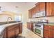 Well-equipped kitchen boasting stainless steel appliances and rich wood cabinets at 8341 Shallow Creek Ct, New Port Richey, FL 34653