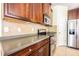 Nicely appointed kitchen featuring stainless steel appliances and dark cabinetry at 8341 Shallow Creek Ct, New Port Richey, FL 34653