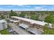 An aerial view of the condo building showcasing covered parking and well maintained landscaping at 9945 47Th Ave N # 203, St Petersburg, FL 33708