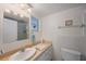 Bathroom with a modern sink, a vanity with storage, and a separate shower area at 9945 47Th Ave N # 203, St Petersburg, FL 33708