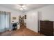 This bedroom features a wall bed, a desk, and brown carpet flooring at 9945 47Th Ave N # 203, St Petersburg, FL 33708