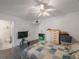 Bedroom with a ceiling fan and comfortable bed with closet and an ensuite bathroom at 9945 47Th Ave N # 203, St Petersburg, FL 33708