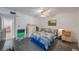 Bright bedroom with a wood floor, a ceiling fan, and a cozy bed with a blue comforter at 9945 47Th Ave N # 203, St Petersburg, FL 33708