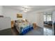 Bedroom with wood floor, comfortable bed, ceiling fan and access to the lanai through a sliding door at 9945 47Th Ave N # 203, St Petersburg, FL 33708
