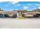 Exterior shot of a condo building with well-lit parking under roof at 9945 47Th Ave N # 203, St Petersburg, FL 33708