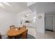Dining area with an adjacent view into a white kitchen at 9945 47Th Ave N # 203, St Petersburg, FL 33708