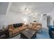 Inviting living room showcasing sofas, carpet, and a glimpse into the kitchen at 9945 47Th Ave N # 203, St Petersburg, FL 33708