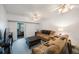 Cozy living room featuring plush sofas, a dark ottoman, and sliding doors to a balcony at 9945 47Th Ave N # 203, St Petersburg, FL 33708