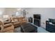 Comfortable living room with a soft, oversized ottoman that matches the brown sofas at 9945 47Th Ave N # 203, St Petersburg, FL 33708
