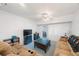 Well-lit living room with sofas, an ottoman, decorative fireplace, and access to the outside at 9945 47Th Ave N # 203, St Petersburg, FL 33708