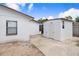 View of the backyard featuring white exterior and detached building with concrete parking pad at 1054 13Th S Ave, St Petersburg, FL 33705