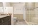 Modern bathroom featuring a glass shower, neutral tile, and wood-look flooring at 1054 13Th S Ave, St Petersburg, FL 33705