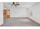 Another view of the carpeted bedroom with a ceiling fan and access to other rooms at 1054 13Th S Ave, St Petersburg, FL 33705