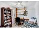 This bedroom features a built-in desk, a bookshelf, and a ceiling fan at 1054 13Th S Ave, St Petersburg, FL 33705