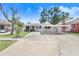 Charming single-story home featuring a covered carport and a well-maintained front yard on a sunny day at 1054 13Th S Ave, St Petersburg, FL 33705
