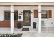 Inviting front porch features a decorative door, lush potted plants, and a cozy seating area at 1054 13Th S Ave, St Petersburg, FL 33705