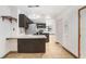 Bright open-concept kitchen features dark cabinetry, granite countertops, and stainless steel appliances at 1054 13Th S Ave, St Petersburg, FL 33705