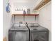 Bright laundry room with new washer and dryer, wood shelf and rod at 1054 13Th S Ave, St Petersburg, FL 33705