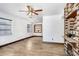 Open-concept living room boasting wood-look tile floors and a distinctive brick fireplace feature at 1054 13Th S Ave, St Petersburg, FL 33705