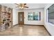 Well-lit living room featuring wood-look tile floors and a unique fireplace feature at 1054 13Th S Ave, St Petersburg, FL 33705