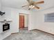 Bright living room features a modern fireplace, neutral carpet, and ample natural light at 1054 13Th S Ave, St Petersburg, FL 33705