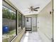 Enclosed sunroom with large windows for natural light and a ceiling fan at 1054 13Th S Ave, St Petersburg, FL 33705