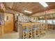 Rustic bar featuring wood accents, a countertop with seating, and unique decor elements at 14800 Walsingham Rd # 301, Largo, FL 33774