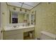 Bathroom featuring yellow wallpaper, a vanity with sink, large mirror, vanity, and toilet at 14800 Walsingham Rd # 301, Largo, FL 33774