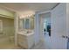 Well-lit bathroom offering a vanity and entrance to other rooms at 14800 Walsingham Rd # 301, Largo, FL 33774