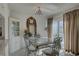 Bright dining room with glass table, decorative mirror, cabinet and outdoor patio access at 14800 Walsingham Rd # 301, Largo, FL 33774