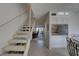 Inviting entryway with a staircase, tile floors, bar access, and an open floorplan at 14800 Walsingham Rd # 301, Largo, FL 33774