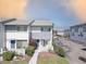The exterior of a condo building with neatly landscaped grounds, flowering shrubs, and convenient parking at 14800 Walsingham Rd # 301, Largo, FL 33774