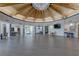Spacious great room featuring wood beam architecture, tables, chairs, and bright natural light at 14800 Walsingham Rd # 301, Largo, FL 33774
