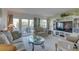 Inviting living room with comfortable seating and glass doors leading to outdoor balcony at 14800 Walsingham Rd # 301, Largo, FL 33774