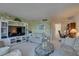 Open living area with entertainment center, comfortable seating, and bright natural light at 14800 Walsingham Rd # 301, Largo, FL 33774