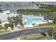 Aerial view of large rectangular community pool with sun loungers and lush landscaping overlooking the bay at 14800 Walsingham Rd # 301, Largo, FL 33774