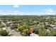 An aerial view showcases the property amidst a lush landscape with a cityscape in the background at 1591 S Prospect Ave, Clearwater, FL 33756