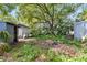 Spacious backyard with lush greenery, mature trees, and storage sheds offering outdoor storage at 1591 S Prospect Ave, Clearwater, FL 33756