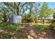 Large backyard with lush greenery, storage shed and a wood fence providing privacy at 1591 S Prospect Ave, Clearwater, FL 33756