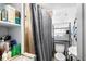 This bathroom features a shower stall, toilet, sink, and storage shelves in the corner at 1591 S Prospect Ave, Clearwater, FL 33756