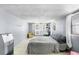 Cozy bedroom is furnished with a bed, chair, desk, and windows offering natural light at 1591 S Prospect Ave, Clearwater, FL 33756