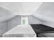 Unique bedroom space with an angled ceiling, a bright window, and a comfortable-looking mattress at 1591 S Prospect Ave, Clearwater, FL 33756