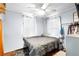 Cozy bedroom featuring a ceiling fan, bed, closet space, and natural light from windows at 1591 S Prospect Ave, Clearwater, FL 33756