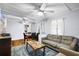 A cozy living room with wood floors, a ceiling fan, a sofa, and a dining table at 1591 S Prospect Ave, Clearwater, FL 33756