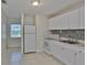 Bright kitchen features white cabinets, appliances, and a modern tile backsplash at 1601 24Th S St, St Petersburg, FL 33712