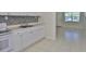 Bright kitchen with tiled floor, white cabinetry, and an open layout at 1601 24Th S St, St Petersburg, FL 33712