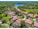 Areal view showcases beautiful homes in a lush neighborhood with a lake nearby at 1819 Bella Casa Ct, Tampa, FL 33618