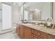 Bright bathroom with granite countertops, wooden cabinets, and neutral tile flooring offers a clean and functional space at 1819 Bella Casa Ct, Tampa, FL 33618