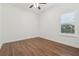 Bedroom with hardwood floors and large window with shutters provides natural light and style at 1819 Bella Casa Ct, Tampa, FL 33618